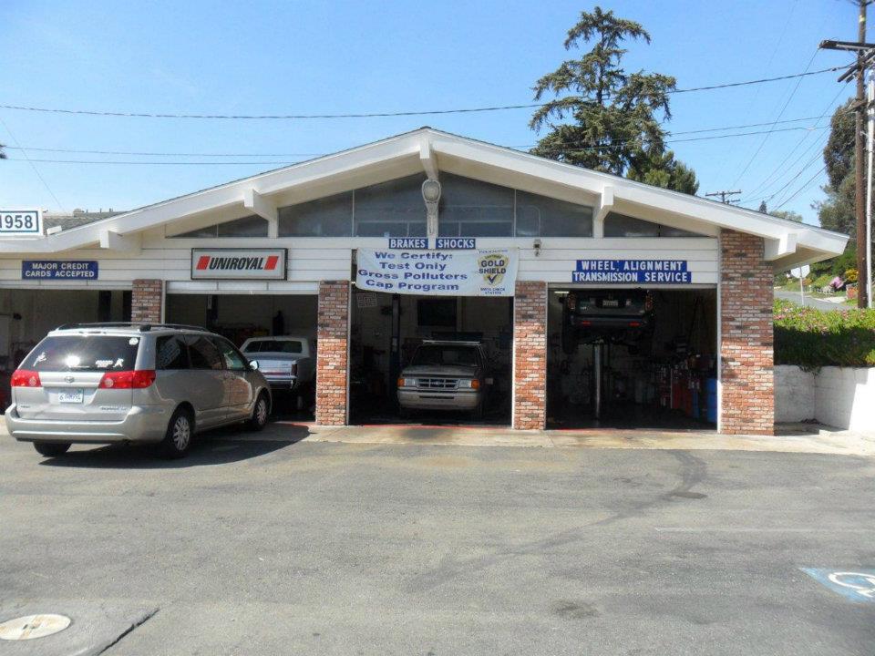 Storefront service bays with brakes, shocks, wheel alignment, transmission and Uniroyal tire signage